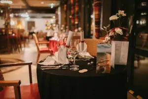 A table with wine glasses and napkins.