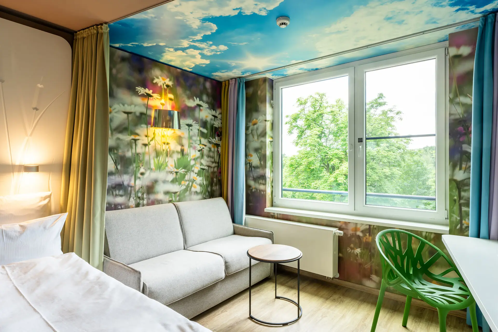 Interior of a room featuring a couch and a coffee table near a window.