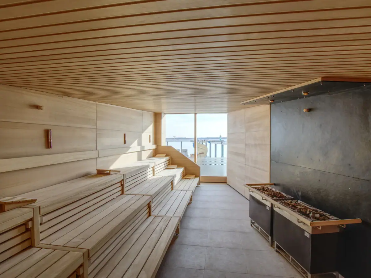 A room with wooden benches and a fireplace.