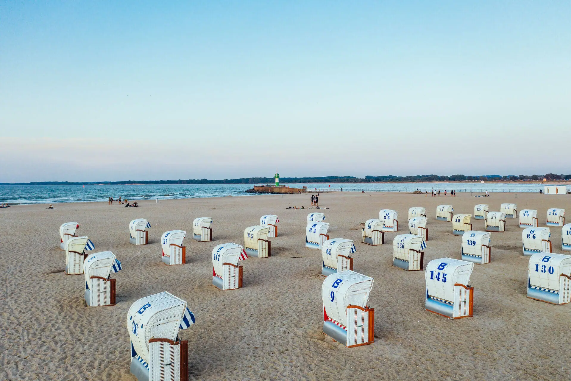 There are many beach chairs on the sandy beach of Travemünde.