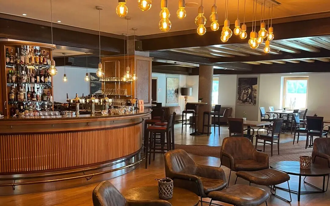 Interior of a room with a bar and chairs.