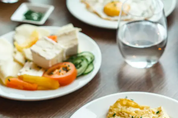 A table with plates full of food and drinks.
