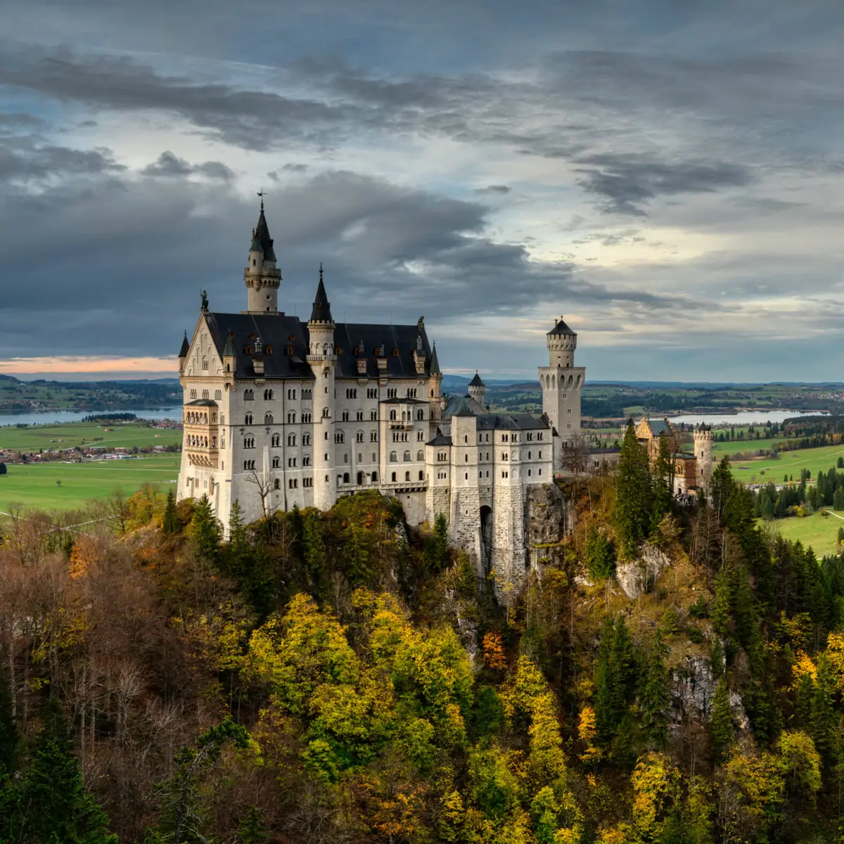 Neuschwanstein Castle Neuschwanstein Castle on a hill with autumnal trees in the foreground.