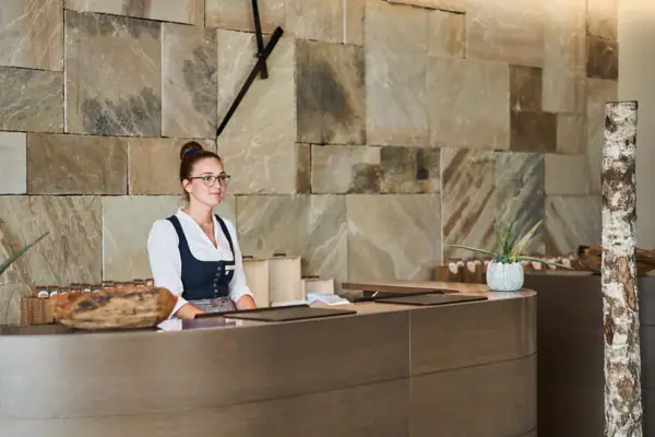 Reception A woman stands behind a counter.