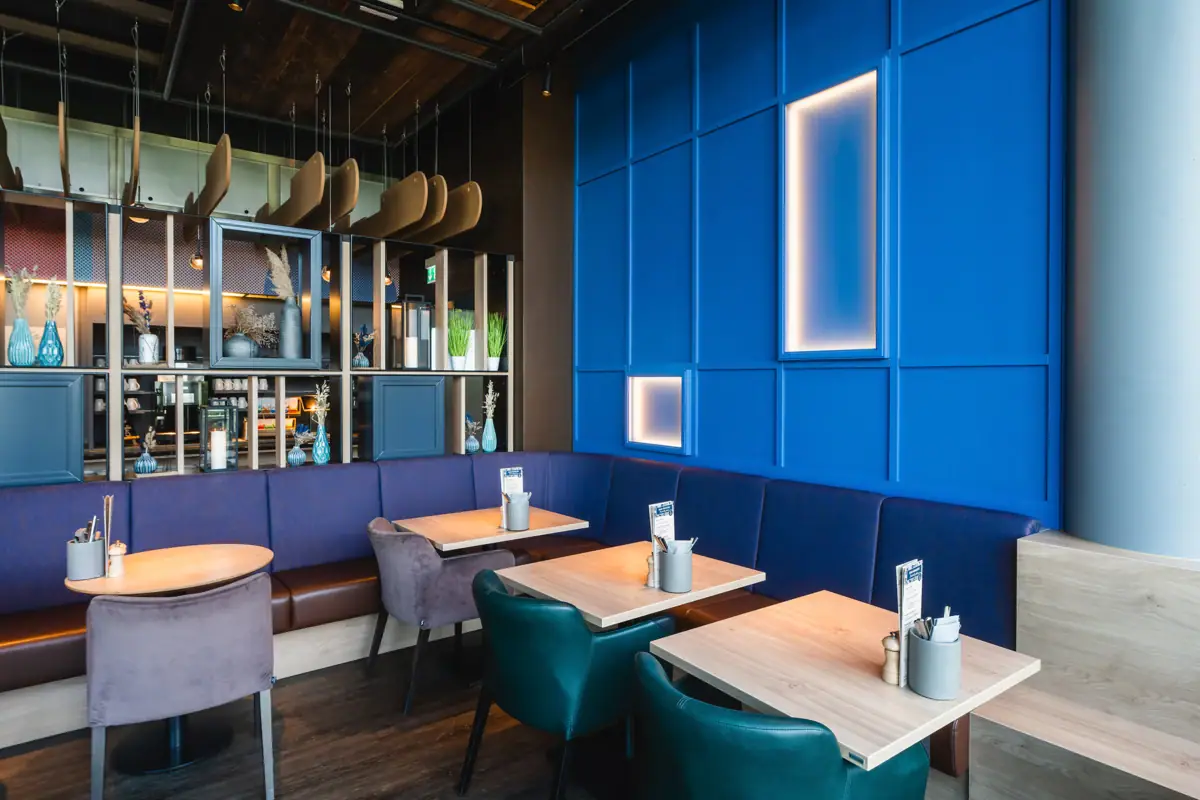 Blue bench with tables and chairs in the restaurant.