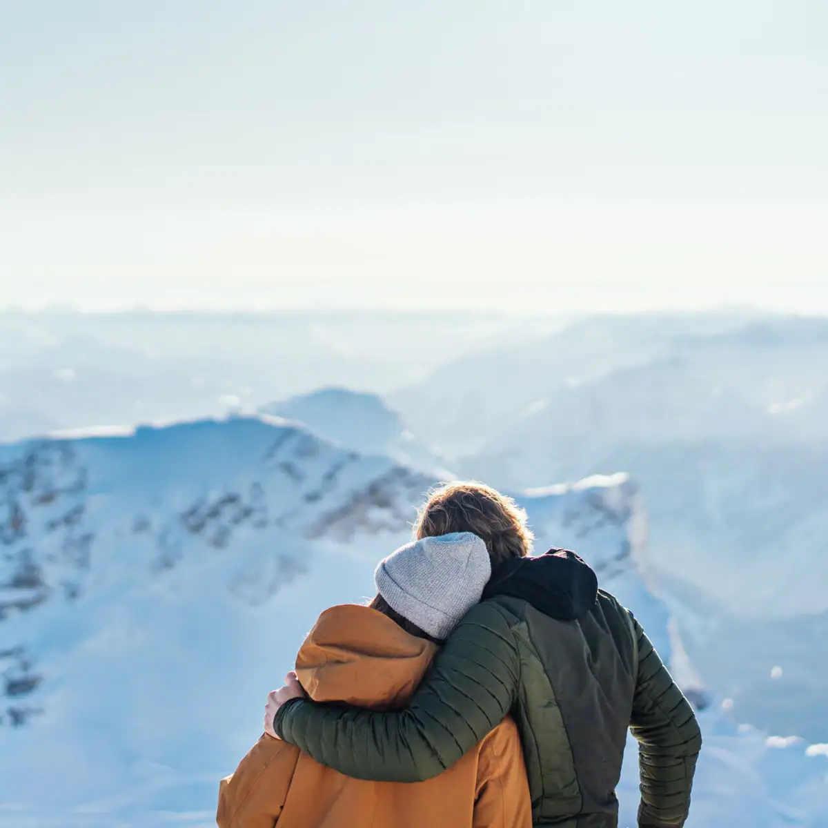 Snow mountains Couple hugging on a snowy mountain.