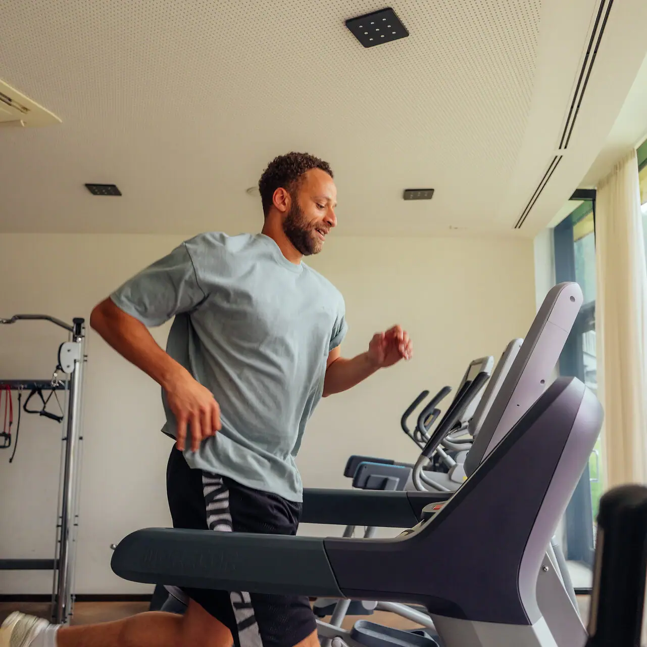 A man is running on a treadmill.