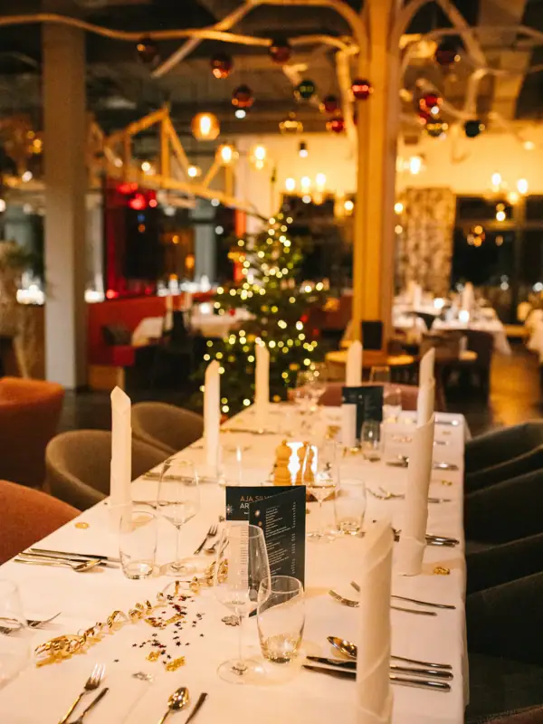 A table festively laid with a set of glasses and candles.