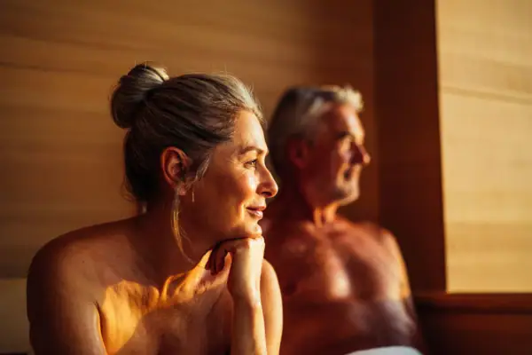 A man and a woman in a sauna.