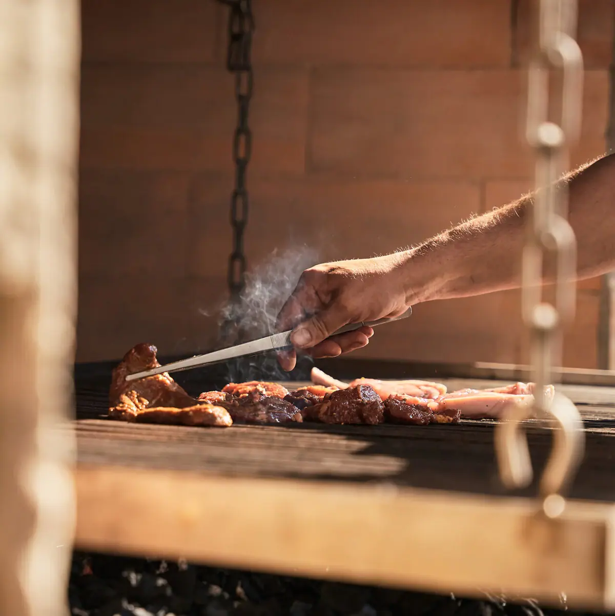 One person grills meat.