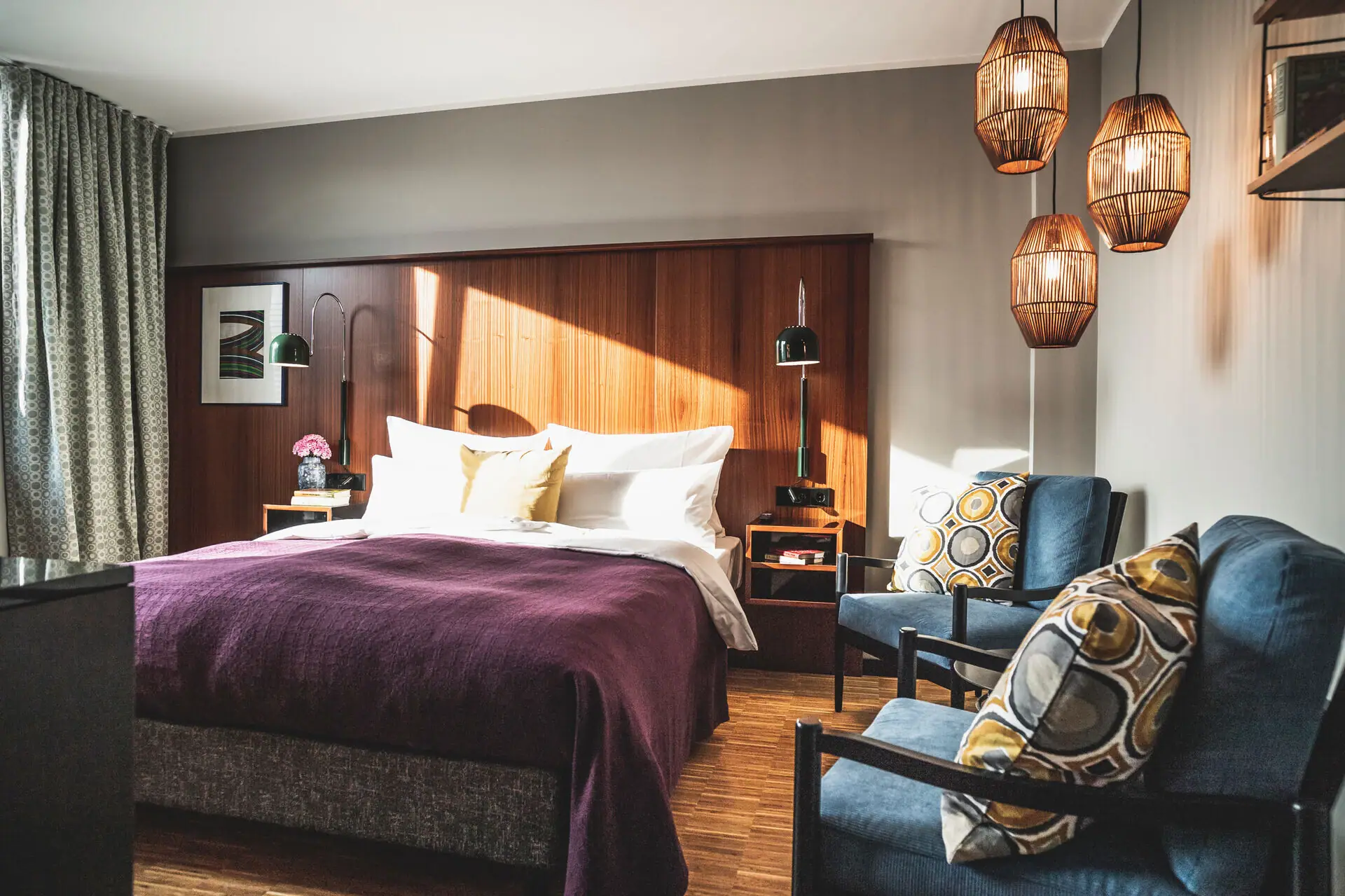 A bedroom with a bed and chairs.