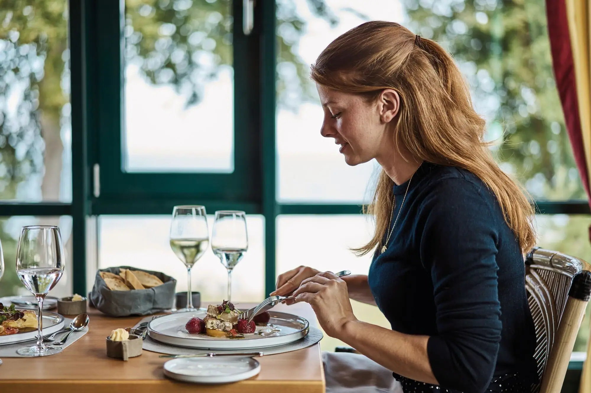 A woman eats at a table.