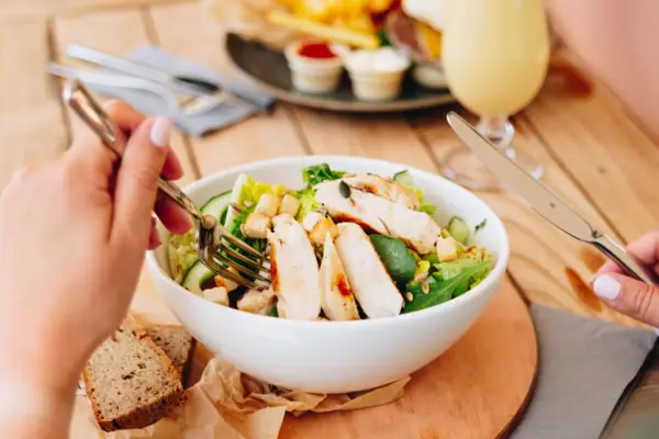 A person eats a salad in the aja Bar Garmisch-Partenkirchen.