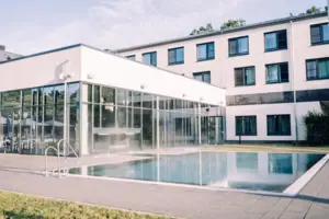 A building with a swimming pool and windows.