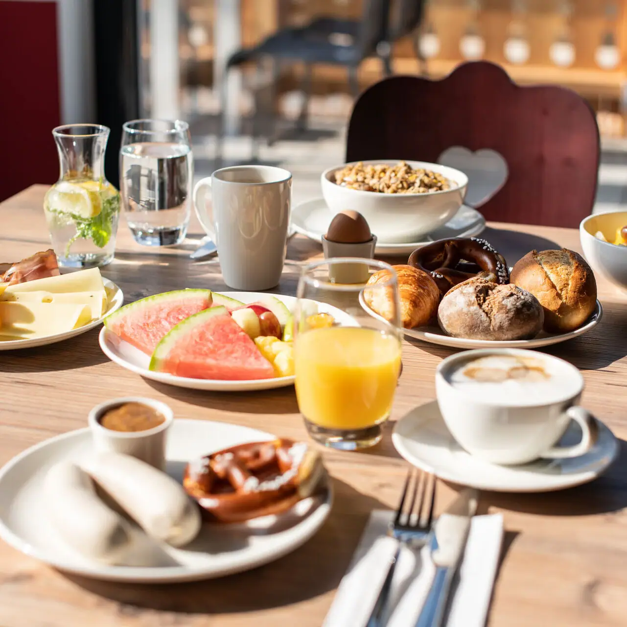 Breakfast A table with various dishes and crockery.
