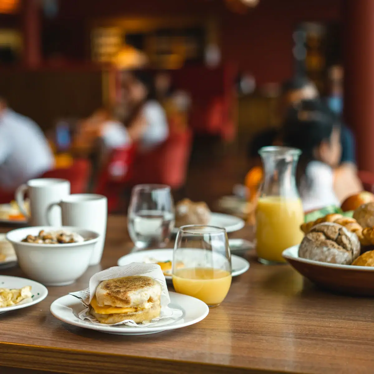 A table with plates full of food and drinks.