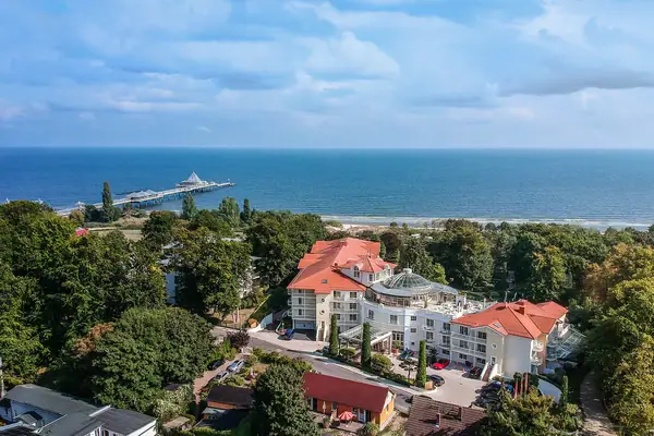 Large building with a pier in the background.