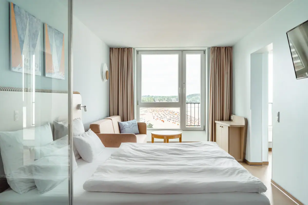 Bedroom Suite A room with a bed, a chair and a table.