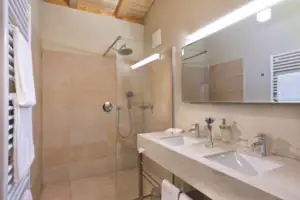 A bathroom with shower and washbasin.