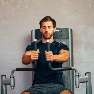 Fitness A man trains on a fitness machine.