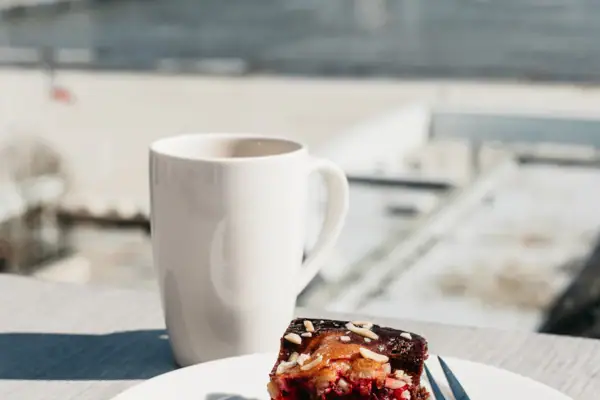 A plate of pastries and a cup of coffee on a table.