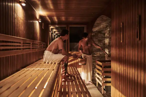 Two men in a sauna.
