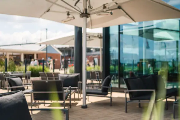 A table with drinks in front of an outdoor building.