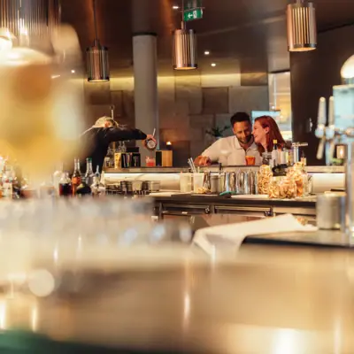 A man and a woman at a bar.