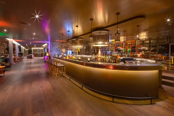 A bar with a counter and stools.
