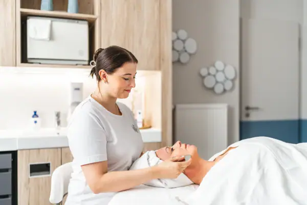 A woman receives a facial massage.