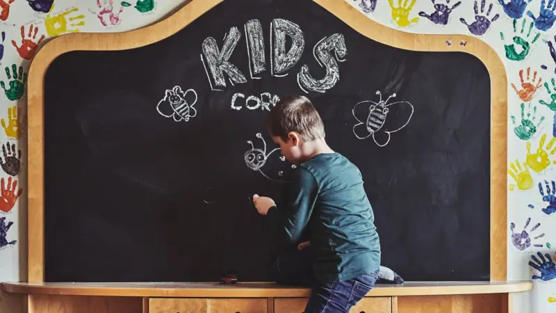 A boy writes on a blackboard.