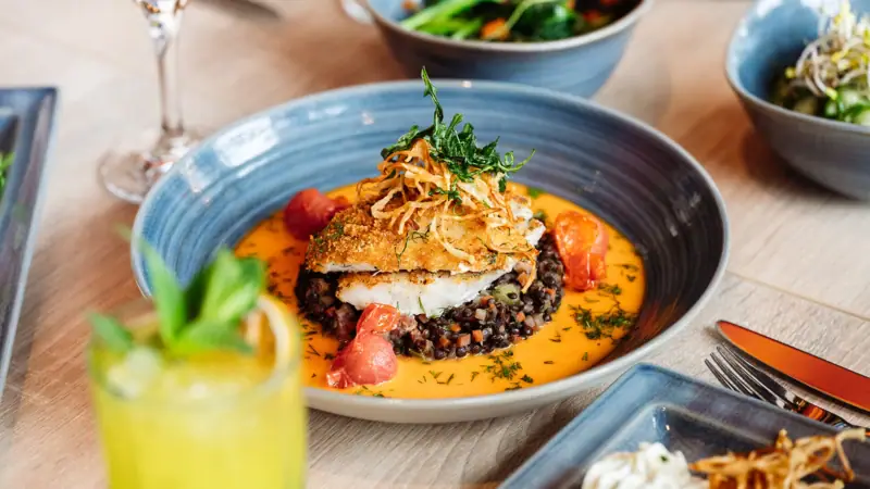 A plate of food on a table with a garnish.