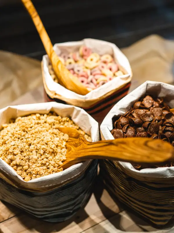 A group of bowls containing muesli and a spoon.