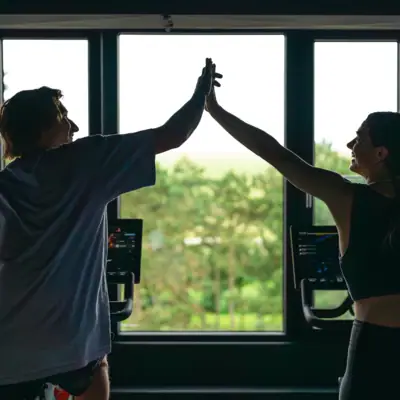 Fitness A man and a woman give each other a high five.