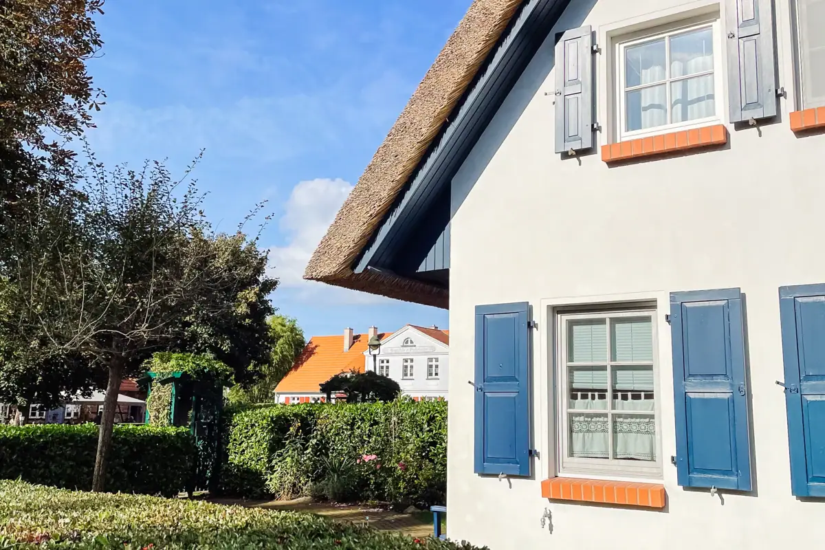 A half-timbered house with lawn and trees.