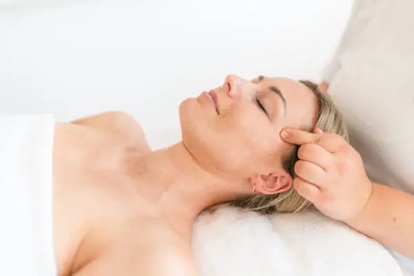 Woman lying on a massage table.