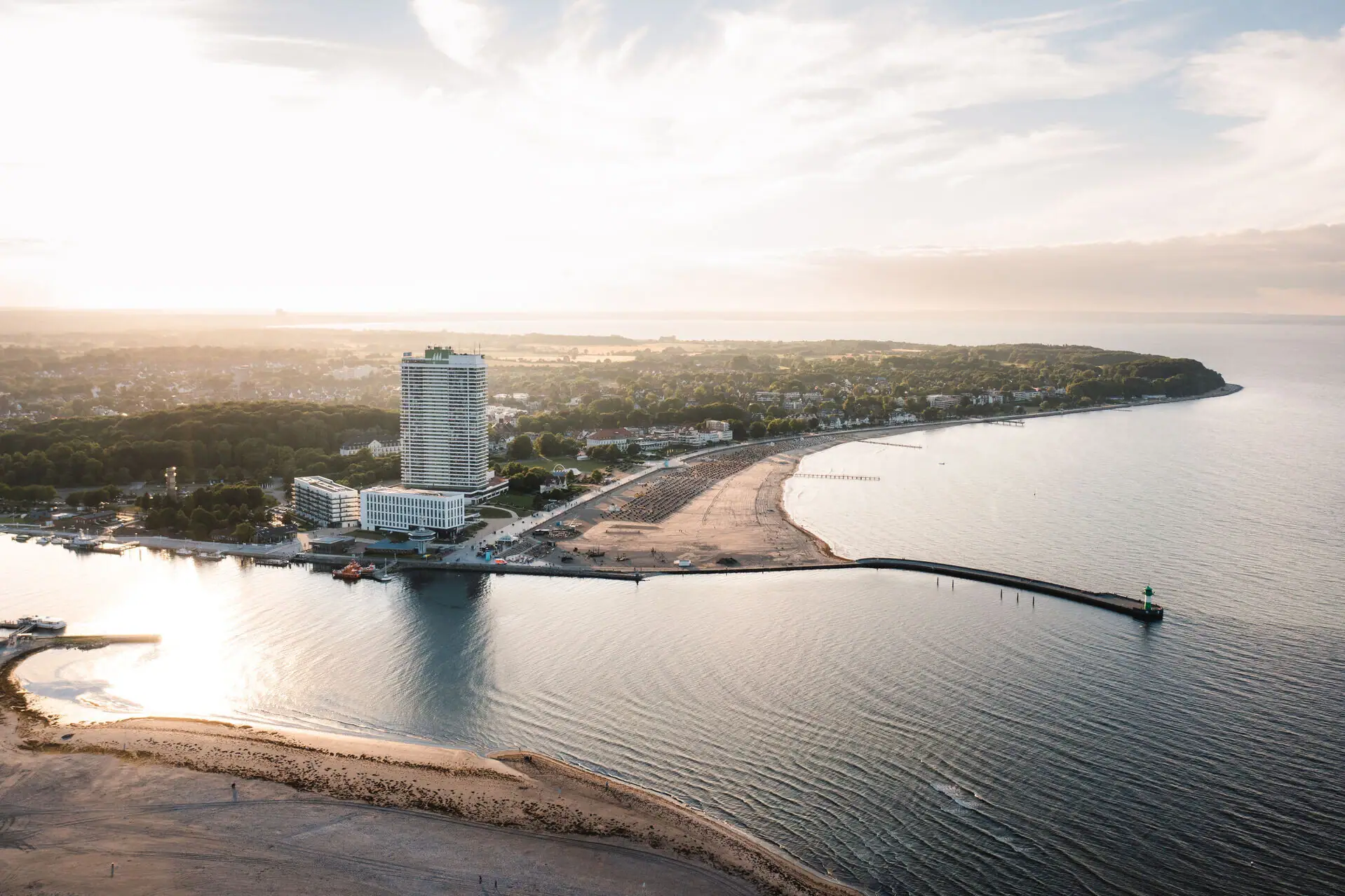 A beach with a body of water and a building.