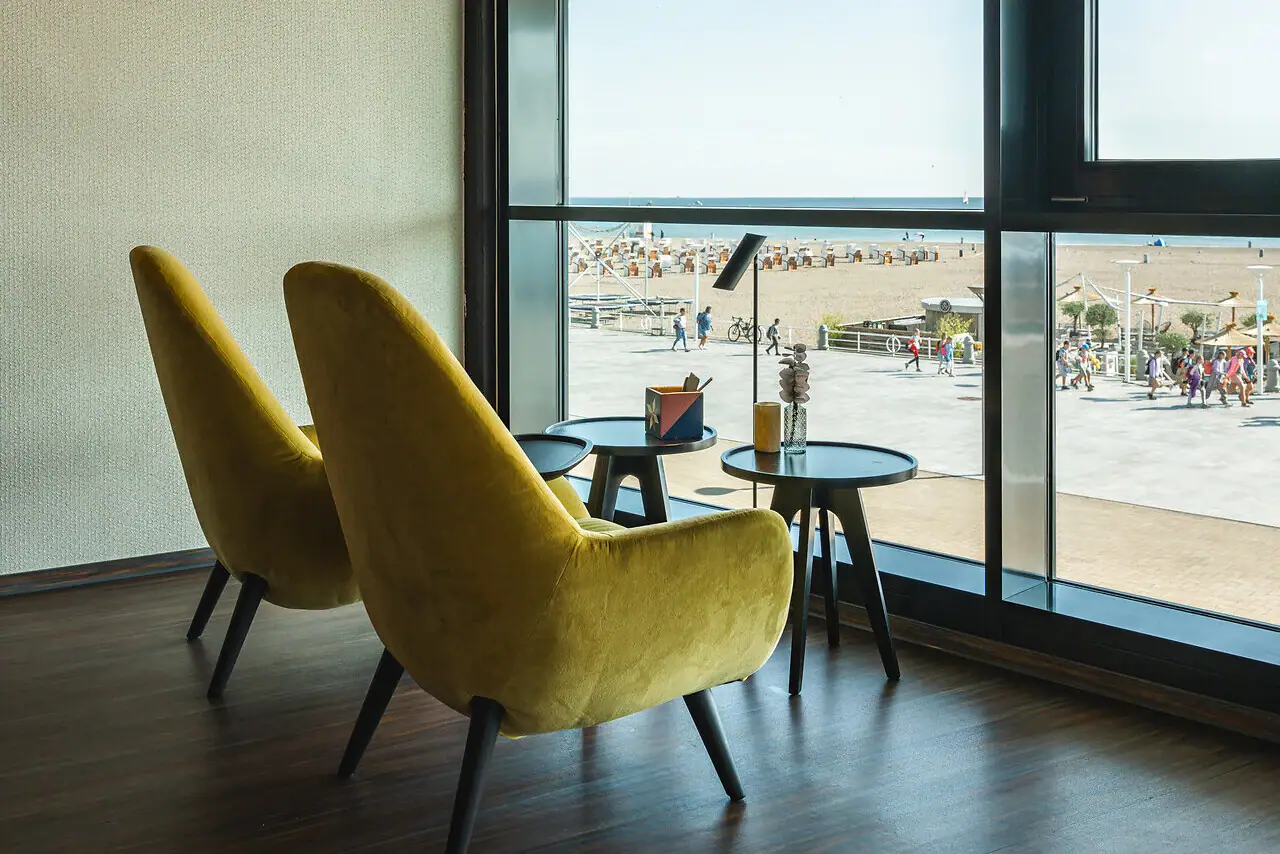 A room with yellow chairs and a table.