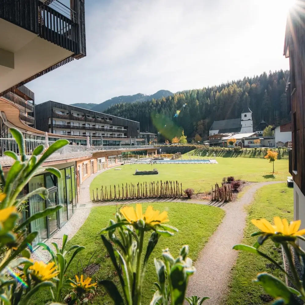 Werfenweng outlook Grassy area with buildings and trees in the background