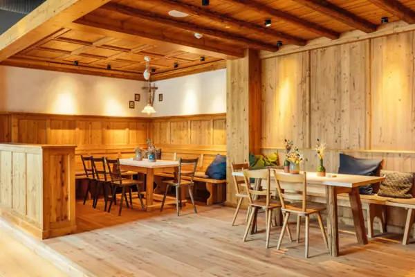 Bavarian parlour A room with wooden walls, tables and chairs.