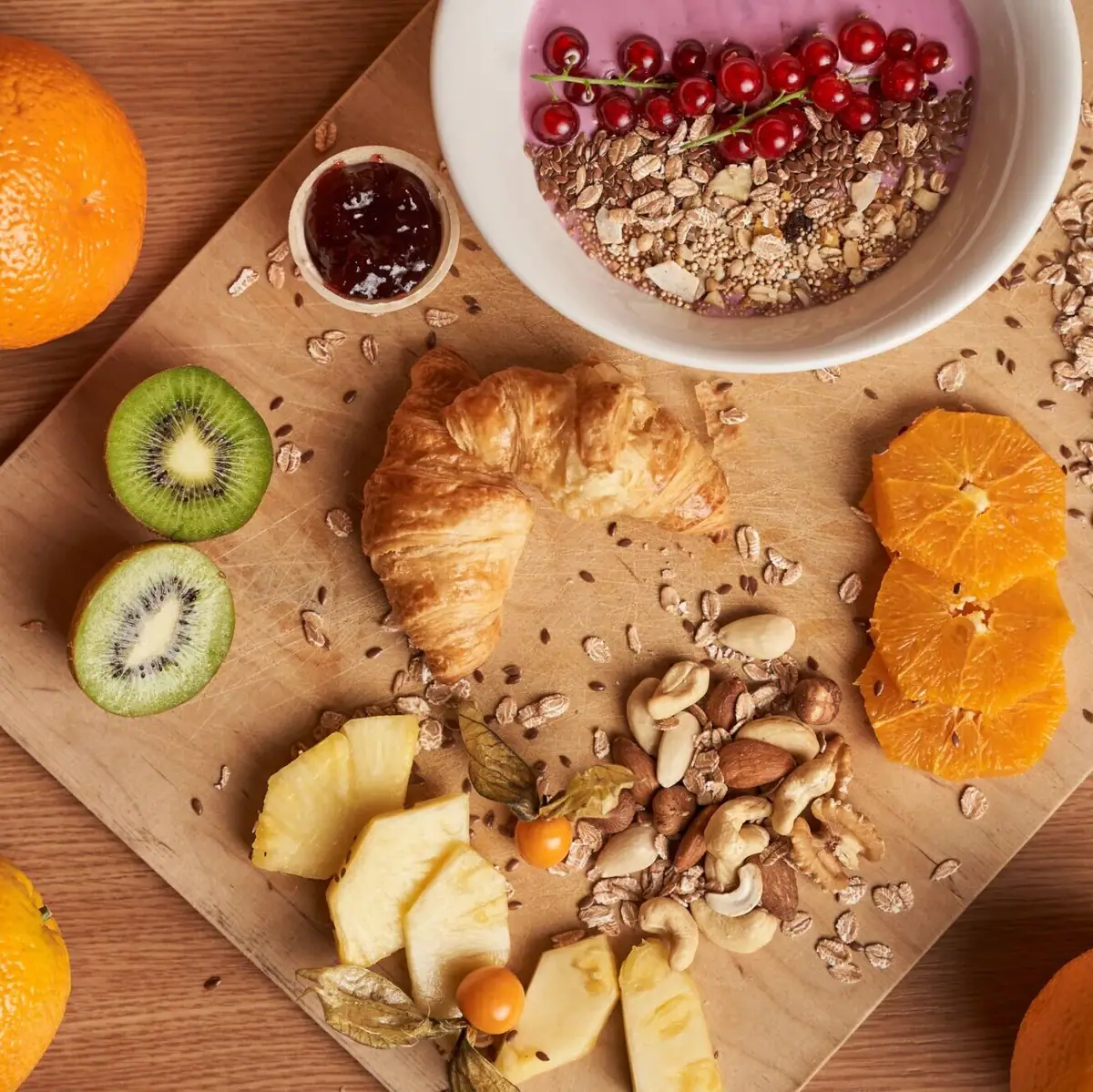Breakfast Plate with fruit and nuts on a wooden surface