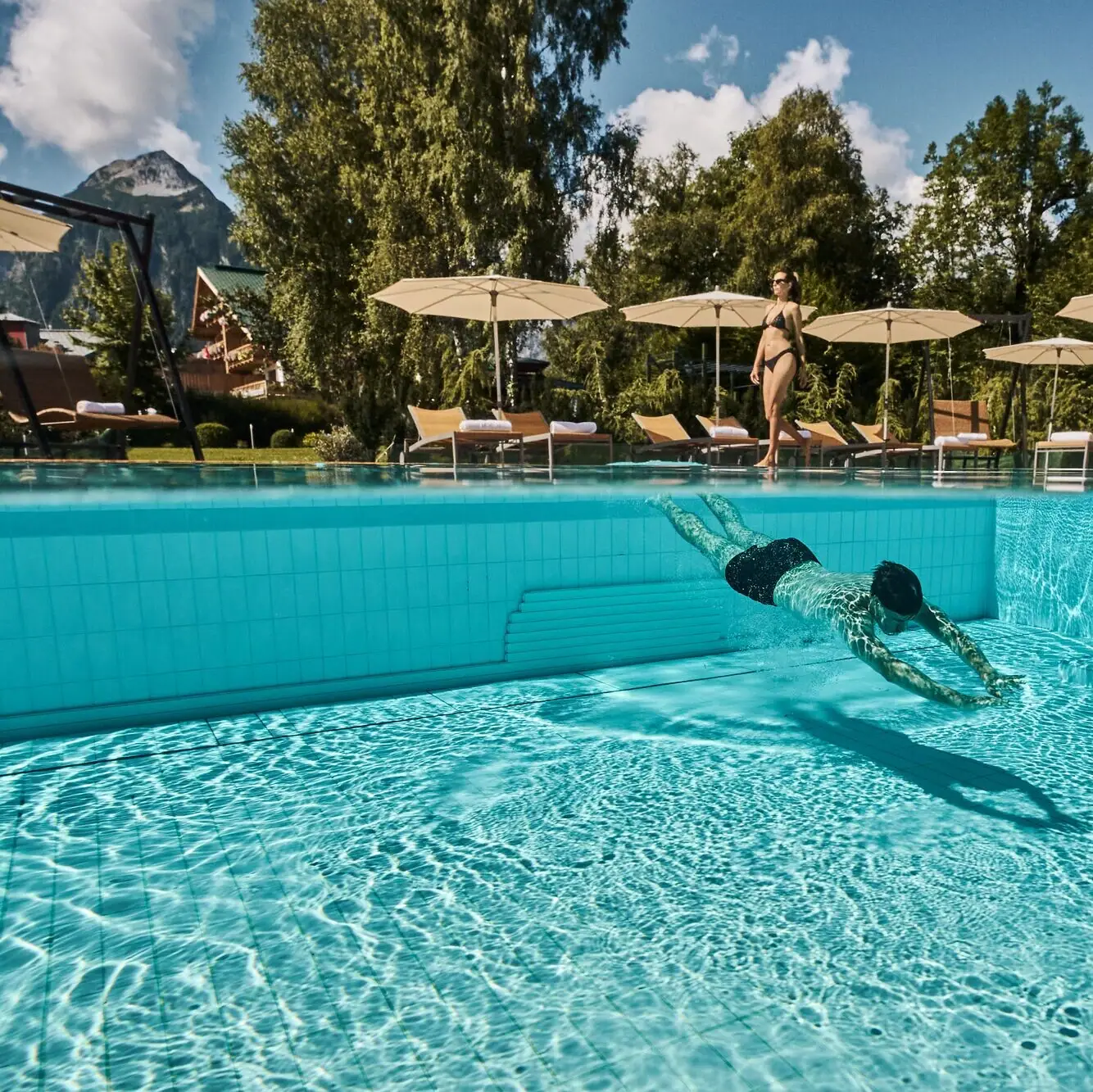 A man swims in a pool.
