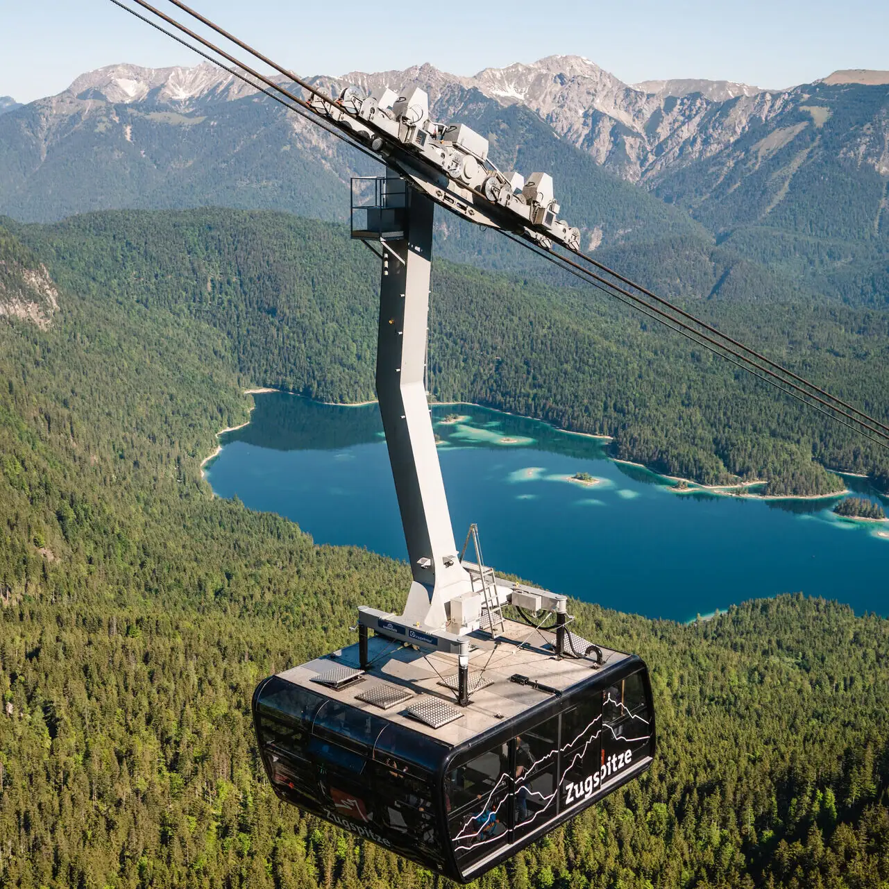 Mountain railway Cable car over a lake with a mountain backdrop.