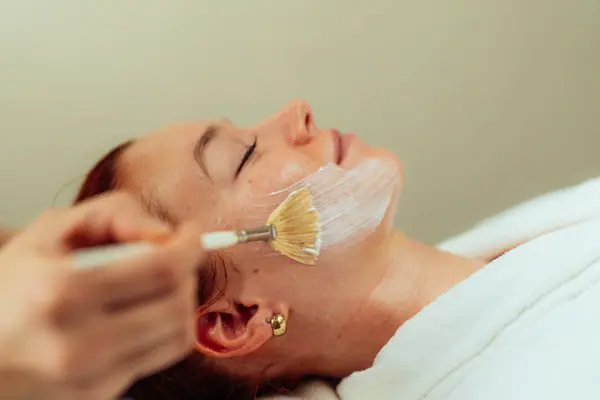 A woman is given a face mask.
