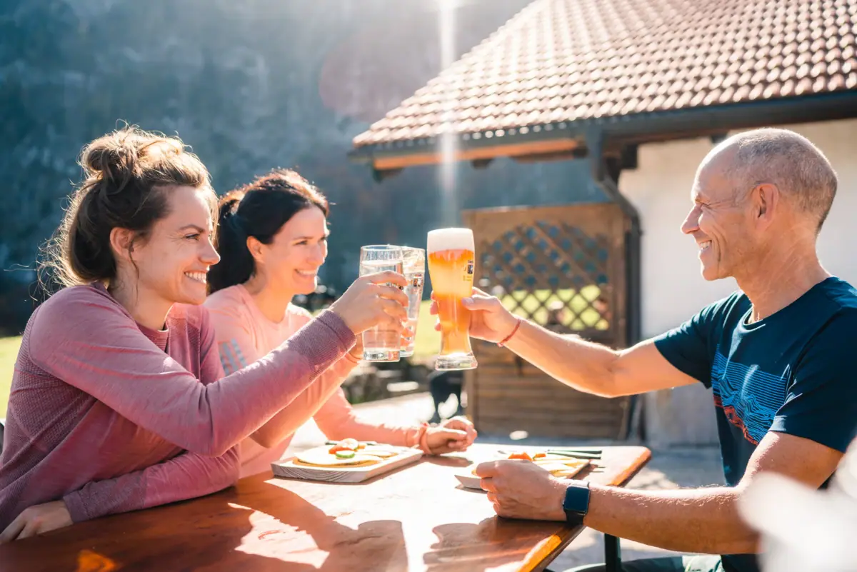 A group of people clink glasses at a table.