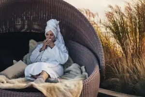 A woman sits in a chair.