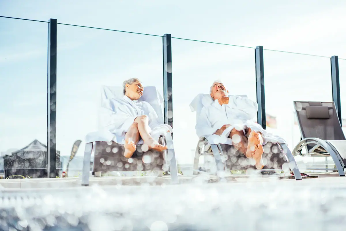 A man and a woman are sitting on chairs.