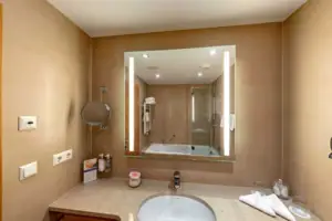 Bathroom A bathroom with a mirror and a washbasin.