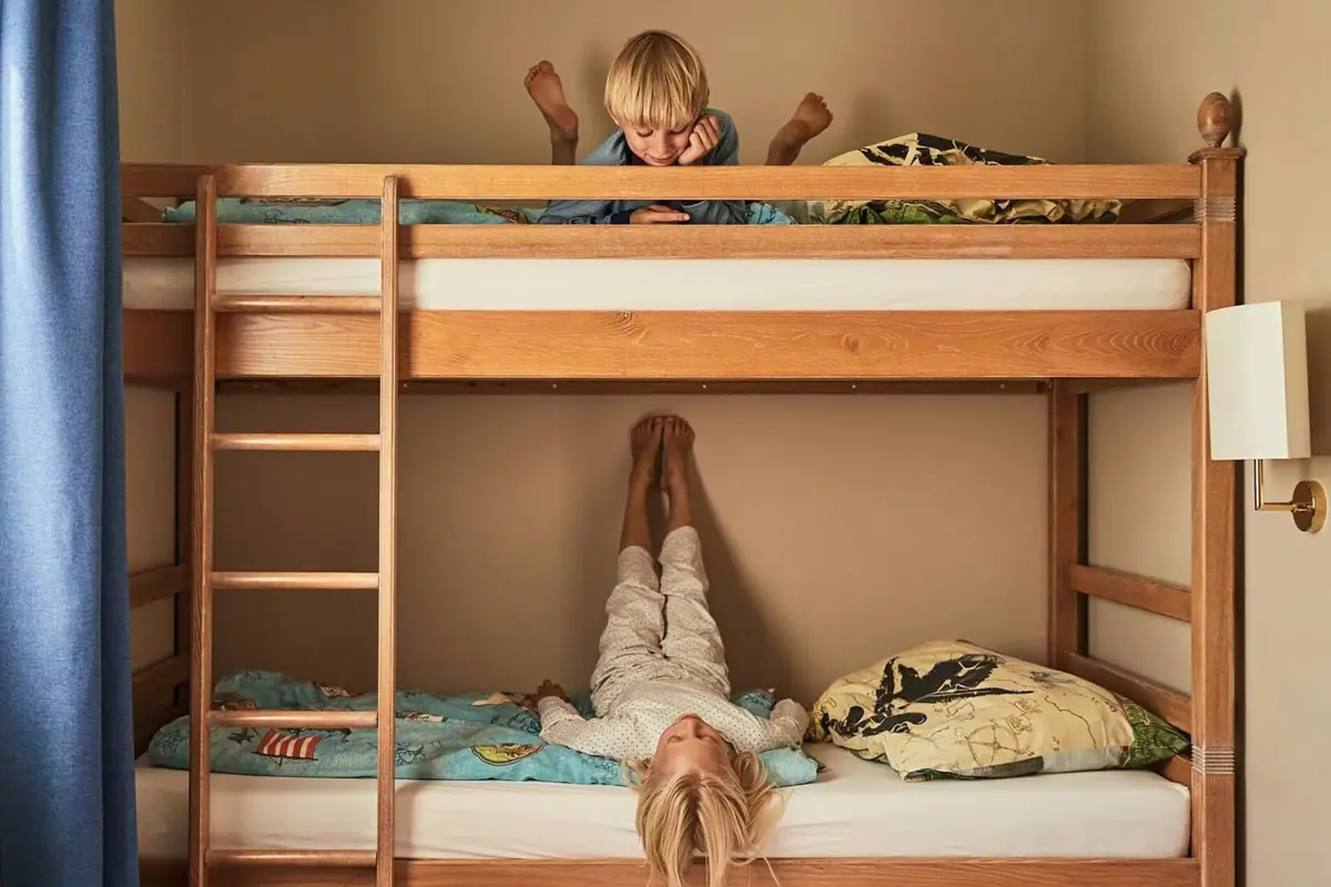 A boy is lying on a loft bed with a ladder.