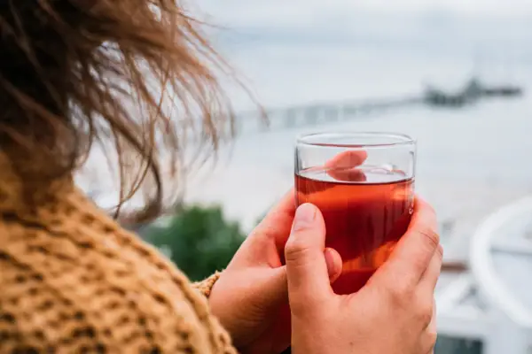 One person is holding a glass with a drink.